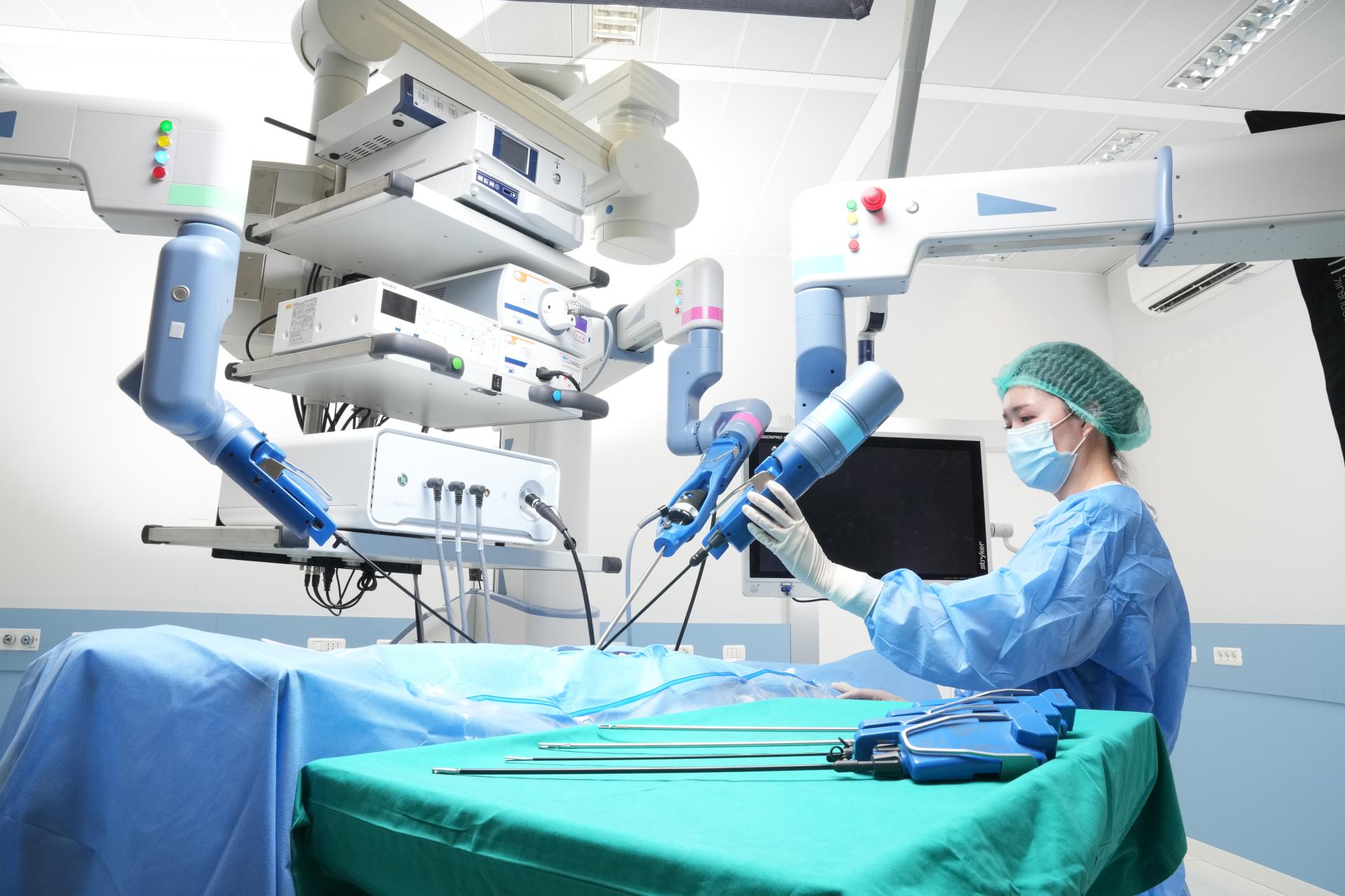 A surgeon holding the arm of a surgical robot
