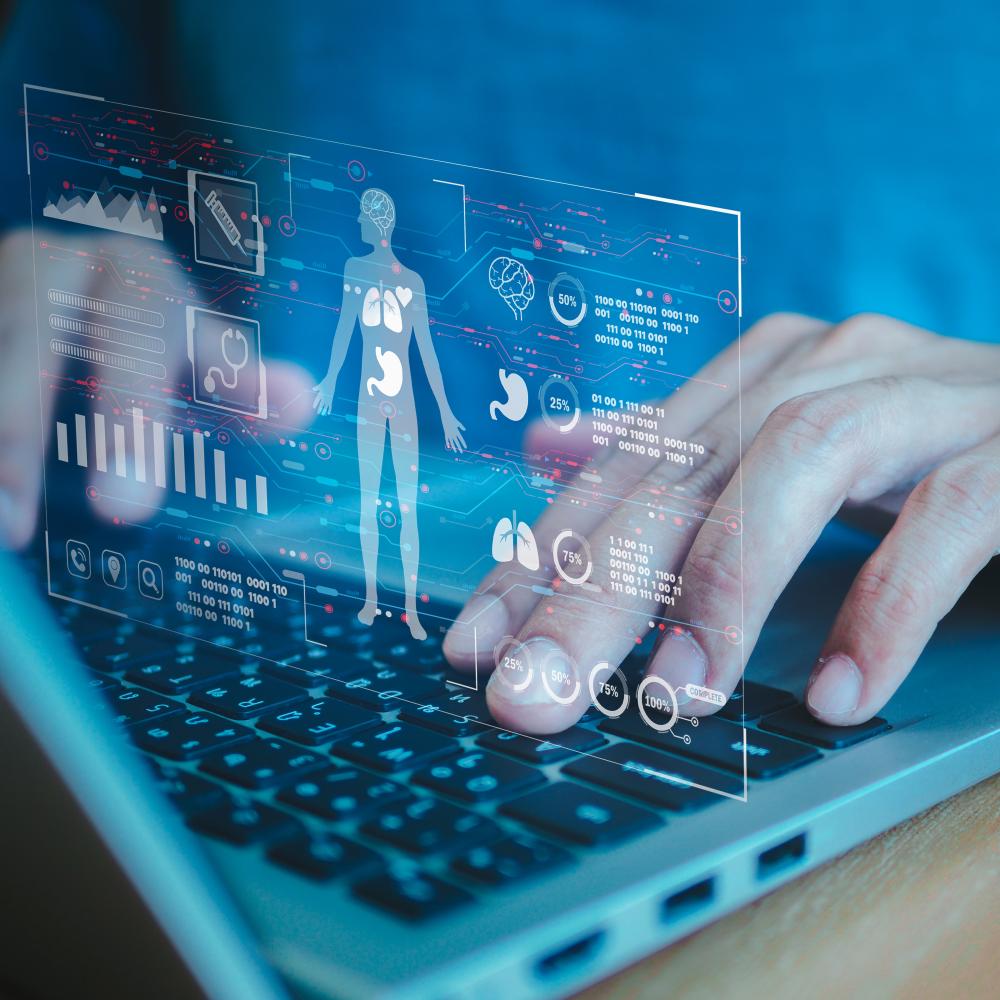 A hologram of a human silhouette hovering over a laptop